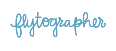 Flytographer brand logo in blue cursive font over a solid black background.