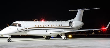 Embraer Legacy 650 sitting on the ramp at night