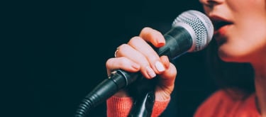 a woman in a red sweater and a microphone