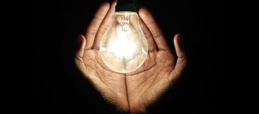 Hand cupping a LED bulb