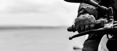 Close up picture of the right hand side of a motorcycle handlebar that is holding the throttle