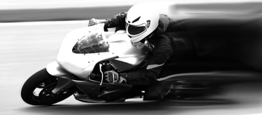 closeup of a motorcycle front end and rider as it is clearly taking a corner