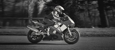 Side view of motorcycle as it ride past from left to right