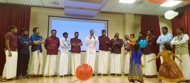 a group of people standing around a balloon - shaped balloon