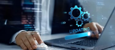 Software developer updating system software with digital gear icons and progress bar overlay.