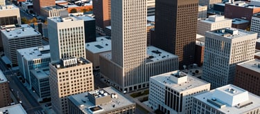 An aerial view of a professional district in a clean, modern Indiana city, symbolizing the growth and reach of the association. Morning light, colors of white and light blue-gray. North American / US / Indiana.