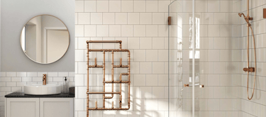 Modern bathroom featuring a copper pipe towel radiator, walk-in shower with copper hardware, and white subway tiles.