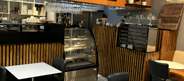 a restaurant with tables and chairs and a counter