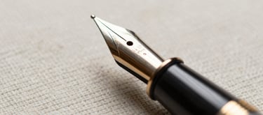 Macro photograph of a vintage fountain pen resting on structured linen paper, soft natural side lighting, warm tones, shallow depth of field.