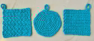 3 aqua crocheted face scrubbies, 2 squares and 1 round shape
