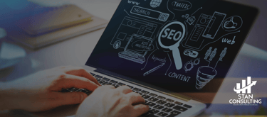 a person sitting at a desk with a laptop and performing SEO