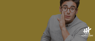 a man with glasses and a gray shirt