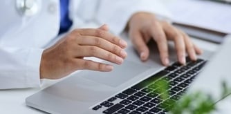 A doctor in front of her laptop