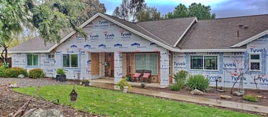 Ranch style home with Tyvek housewarp and new windows.