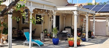 Ornate style wood pergola over a patio.