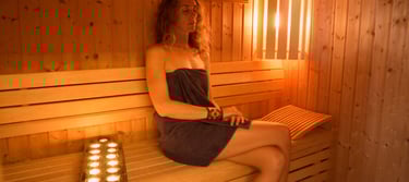 Woman meditating in a sauna.