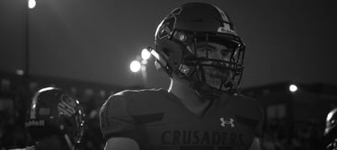 a man in a helmet and a helmet on a football field