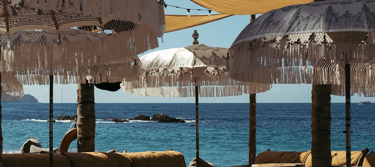 a beach with umbrellas and umbrellas on the beach