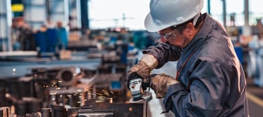 a man in a hard hat and a helmet on a machine