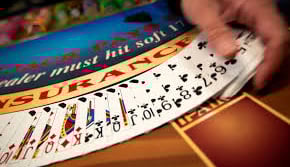 Playing cards fanned out at the blackjack table.