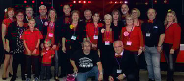 a group of people standing in front of a stage