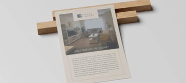 Flyer promocional de Bárzaga Interiors puesto sobre dos listones pequeños de madera