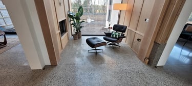 chair in a room fith polisherd concrete floot