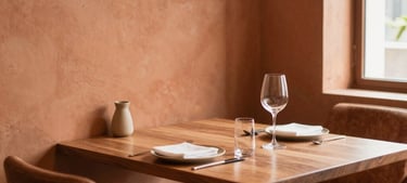 Warm inviting dining room corner of Lotus Plaza, minimalist contemporary Indian decor, terracotta accents, soft diffused daylight