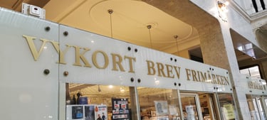 a storefront of a storefront with a sign that brev och vykort