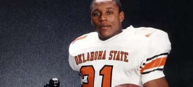 Barry Sanders posing with his Heisman Trophy in 1988.