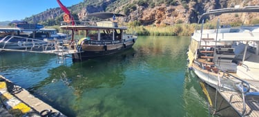 a boat is docked at a dock with a crane