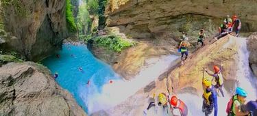 several group of people in helmets canyoneering