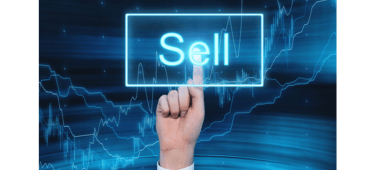 a person pointing to a sell sign that says sell