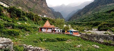 a small village in the mountains with a mountain in the background