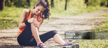 a woman sitting on a dirt road with her leggings