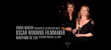 Vibha Bakshi & Maryann DeLeo holding a trophy for the oscar award