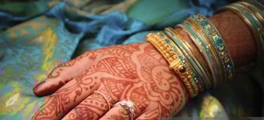a woman's hands with hennakes and rings