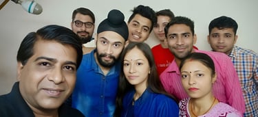 a group of people standing around a man in a blue shirt