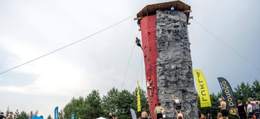 people climbing on a climbing tower