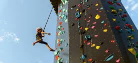 a child climbing on a climbing tower