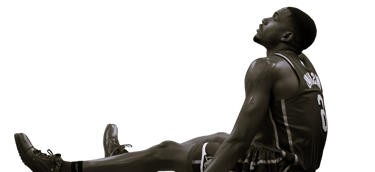 a man sitting on the ground with his feet up and his legs crossed