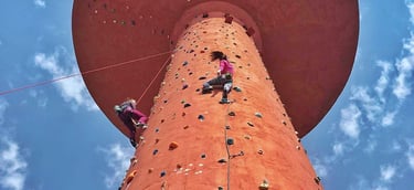 a person climbing on a climbing tower