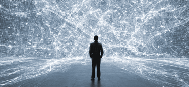 a man standing in front of a large, white and blue light