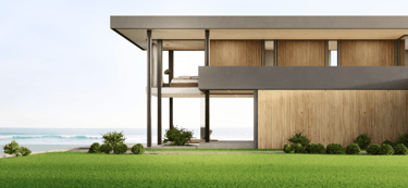 a house with a large lawn and a wooden deck