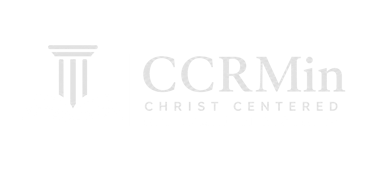 White logo for Christ Centered Reformed Ministries featuring an open Bible and a classic pillar column.
