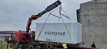 Mirrored Cabin transported on a truck trailer