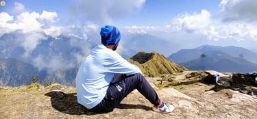 View from Chandrashila Summit, Uttarakhand Himalayas, panoramic snow-capped peaks and sky.