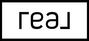 a black and white sign that says, 'real'