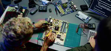 Electronics prototyping and board testing at a workbench.
