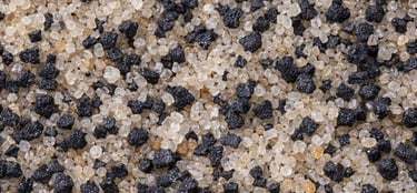 Close-up of silica sand and black rubber granules for artificial turf infill systems.